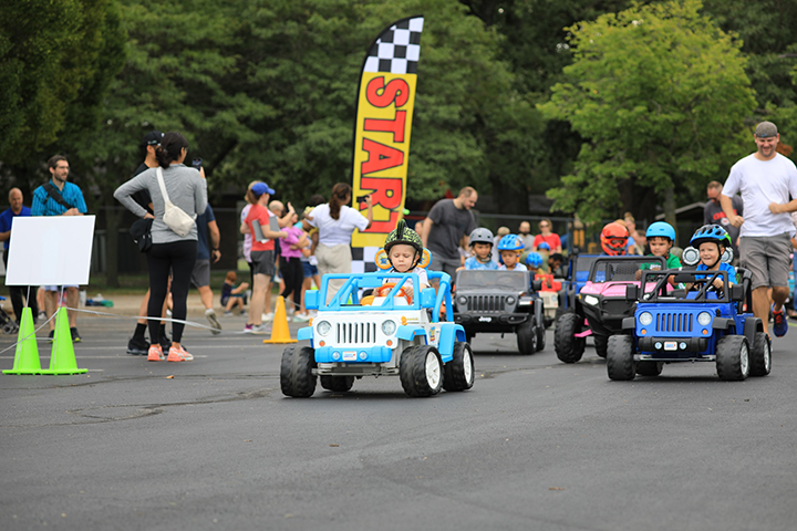 Racers driving the Power Wheels Grand Prix course.
