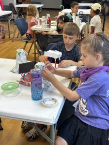 Kids crafting an art project with foil.