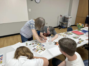 An art instructor teachings drawing skills to an adult.