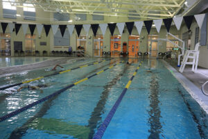 Lap swimmers swim in their respective lanes in the lap pool.