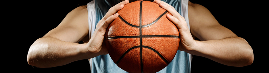 A player holding a basketball in front of their chest.