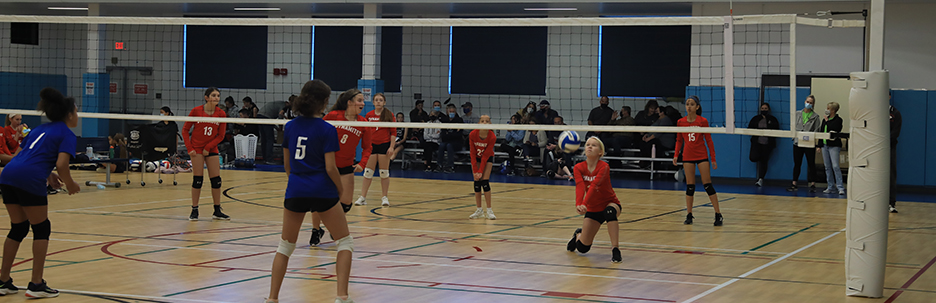 A young girl receives a serve during a Spring Youth Volleyball League match.