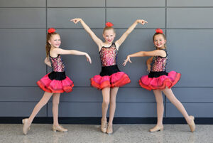 Three performers of the Blue Valley Rec Dance Company pose.