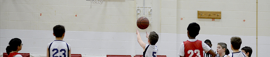 A young basketball player shoots a free throw.