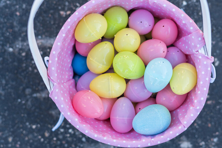 Plastic eggs in a white basket.