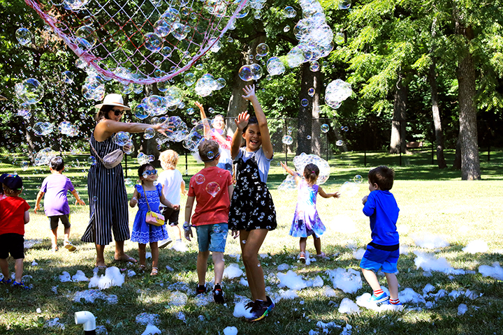 kids play in large bubbles.